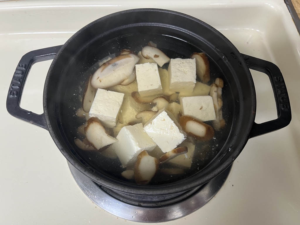 Simmering frozen sliced shiitake mushrooms from Trader Joe’s to bring out natural umami for miso soup