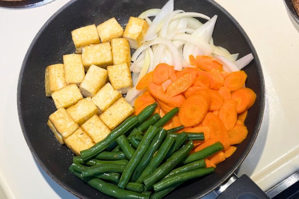 Finishing Miso Salmon with Extra Glaze Vegetables added to the side of the pan with tofu pushed aside for miso tofu stir-fry.