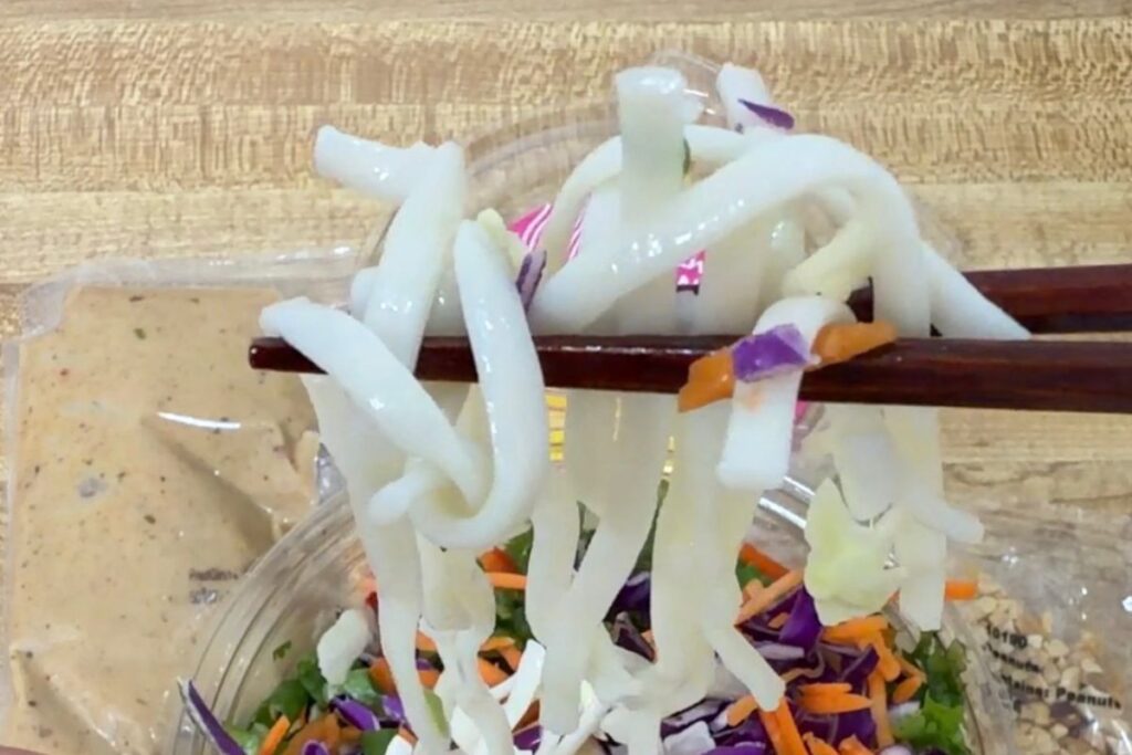 Close-up of udon noodles from Trader Joe’s Peanut Udon Noodle Salad, showing soft texture similar to wide somen