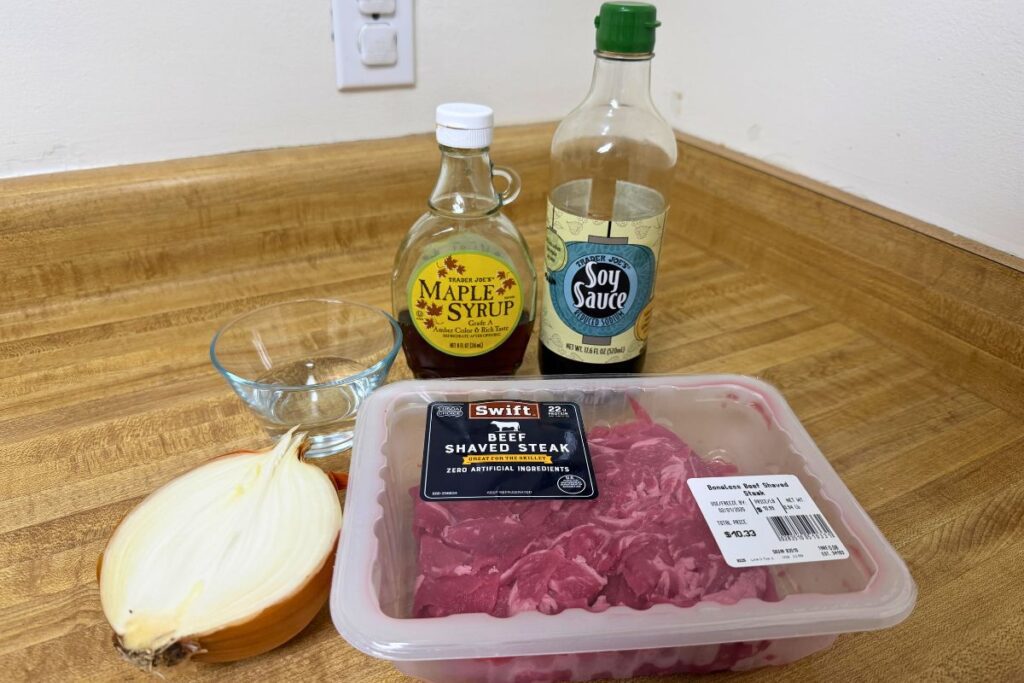 Ingredients for easy gyudon made with Trader Joe’s shaved beef, onion, soy sauce, maple syrup, and white rice