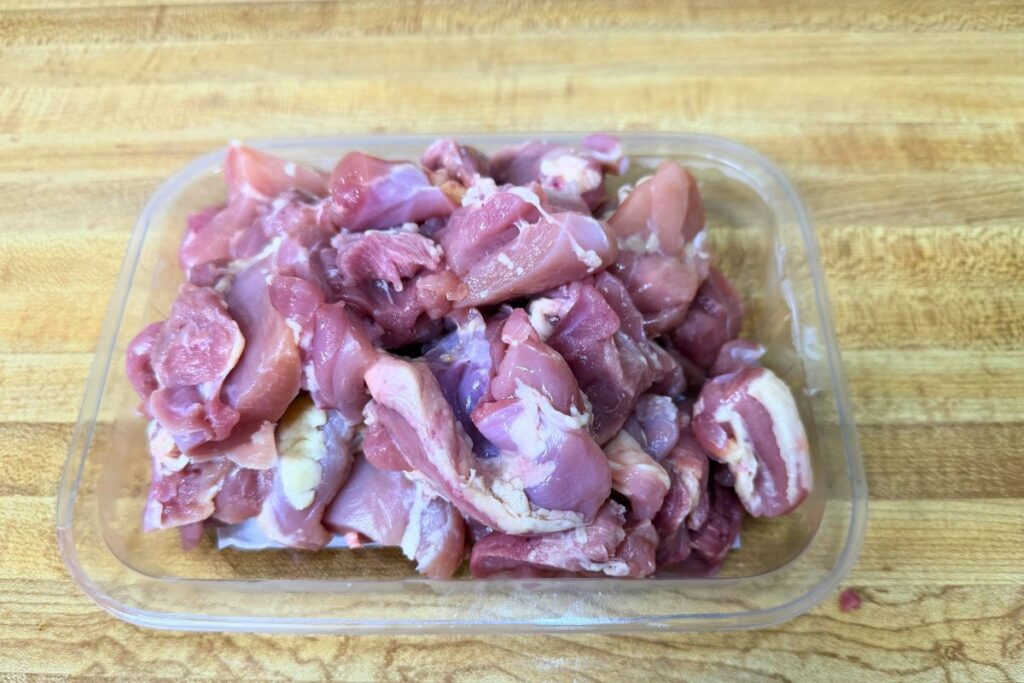 Cutting boneless skinless chicken thighs for teriyaki chicken rice bowl