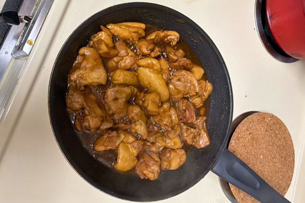 Glossy teriyaki chicken simmering in sauce