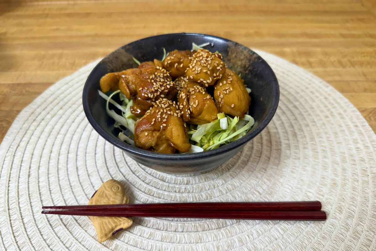 Teriyaki chicken rice bowl with shredded cabbage and sesame seeds, made with Trader Joe’s ingredients