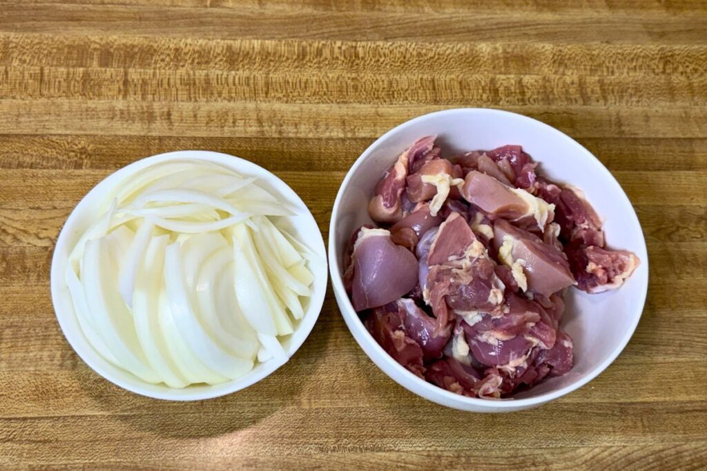 Prepping chicken thighs, slicing onion, and beating eggs for oyakodon
